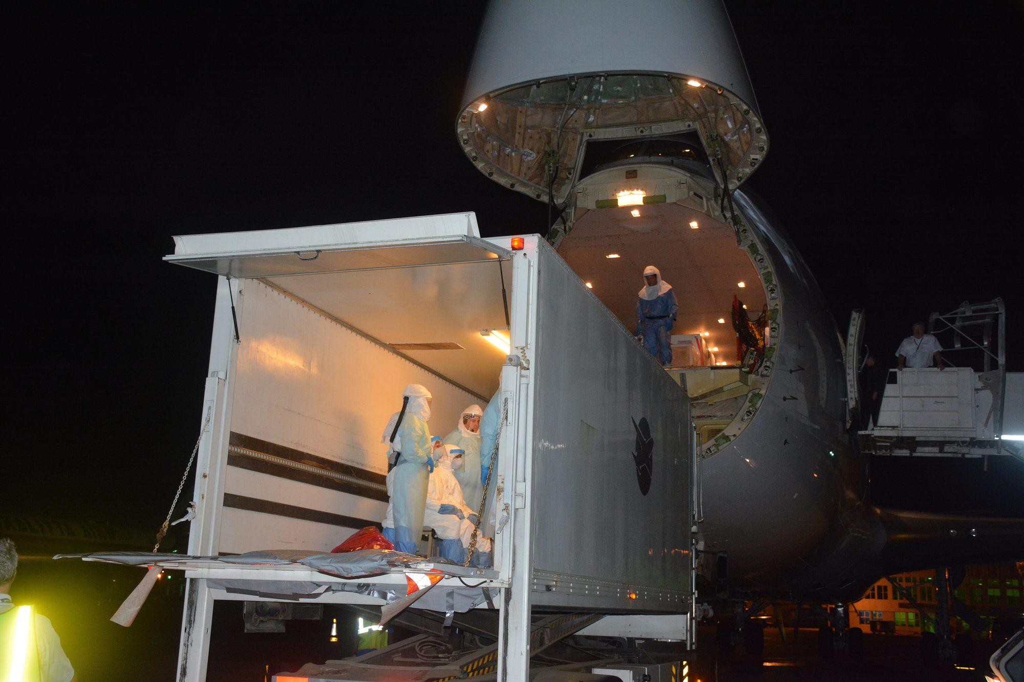 Containerised freight being loaded through the nose door of a cargo aircraft